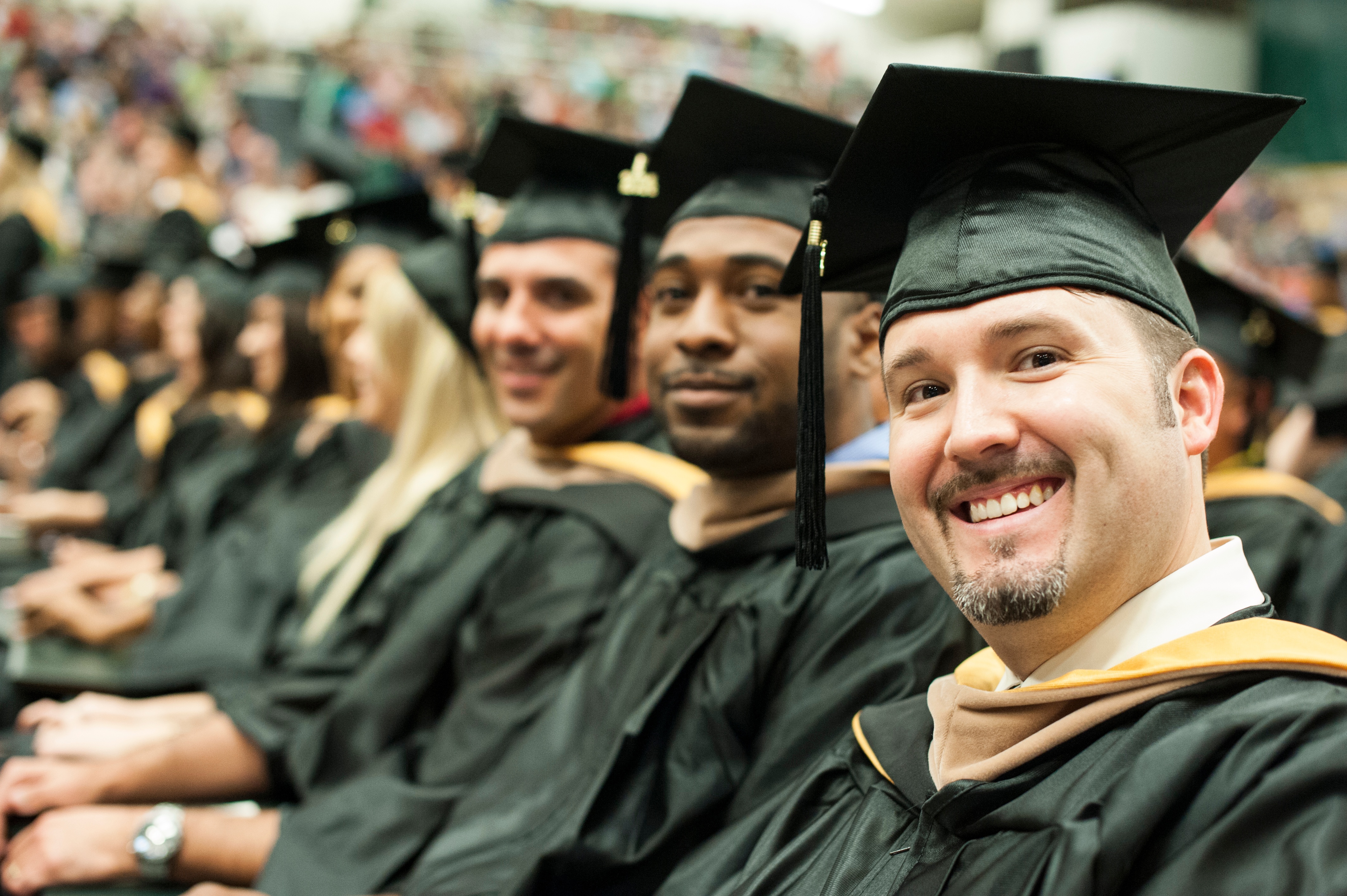 A student graduating with a master's degree